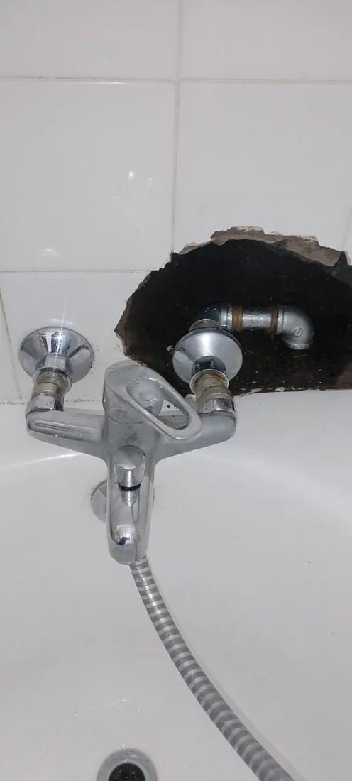 Hidden bathroom leak behind bath mixer pipework and opened tiles in Sandton
