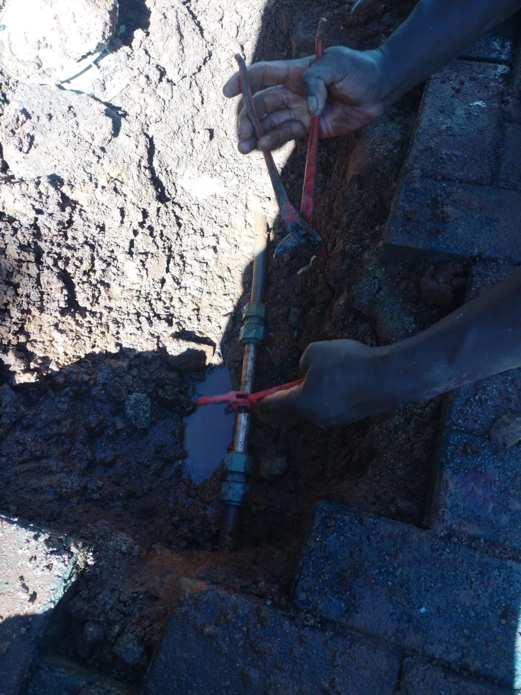 Emergency copper pipe repair in a Sandton garden near Rivonia Road